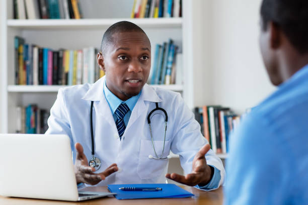 African american doctor has bad news for male patient at hospital